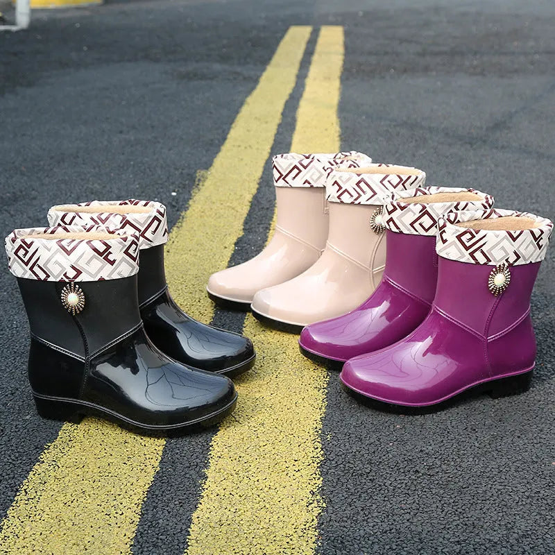 Women's middle tube PVC rain boots in beige, black, and purple with a non-slip sole.
