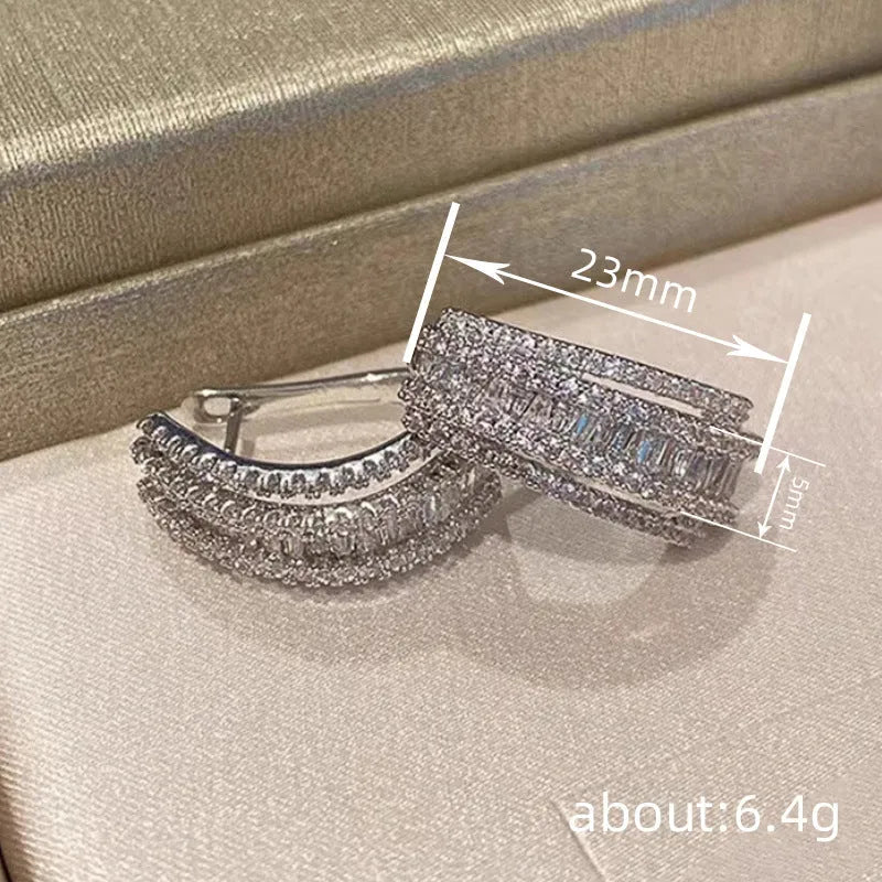 Geometric stud earrings with zircon stones in white gold colour on copper base