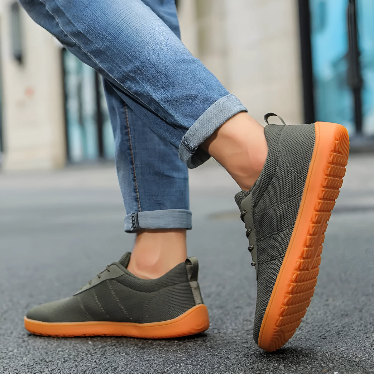 Men's wide toe walking shoes in black with Flyknit upper and rubber sole on a plain background.