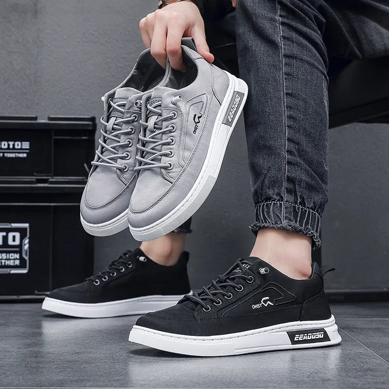 Grey men's canvas lace-up sneakers with round toe and low-top design on a rubber sole.