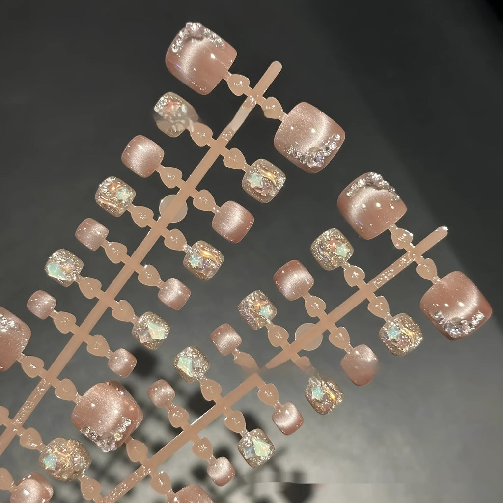 Nude cat eye toenail wear with hand-applied white diamond studs in a smiling pattern, 42 pieces in sizes S M L
