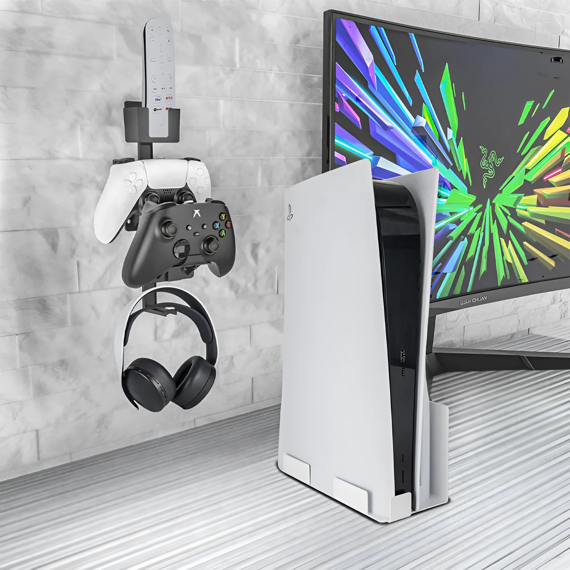 White wall-mounted plastic hook holding a game controller and a TV remote control.