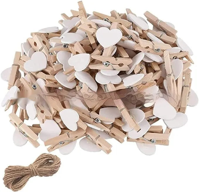 A set of five handmade wooden heart-shaped clips in assorted colours on a plain background.