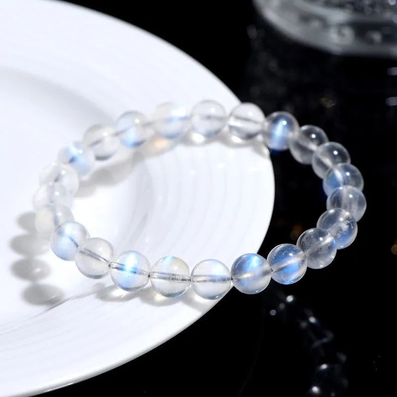 Natural cream body blue moonlight crystal bracelet showing simple design and crystal details.