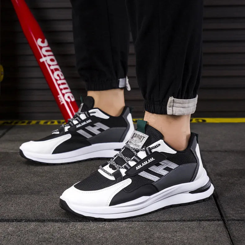 Men's sports sneakers in light grey or black with PU and mesh upper, front tie fastening, plastic sole, sizes 39-44