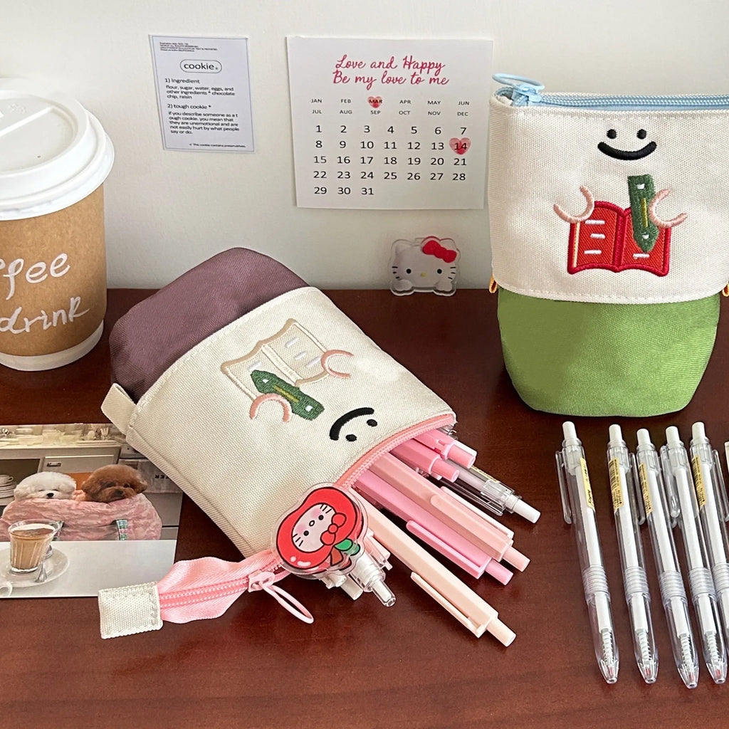 Brown collapsible pencil case with cartoon print, showing 17cm by 14cm size.