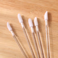 Pack of disposable lip brushes with flocked cotton heads and black plastic handles.