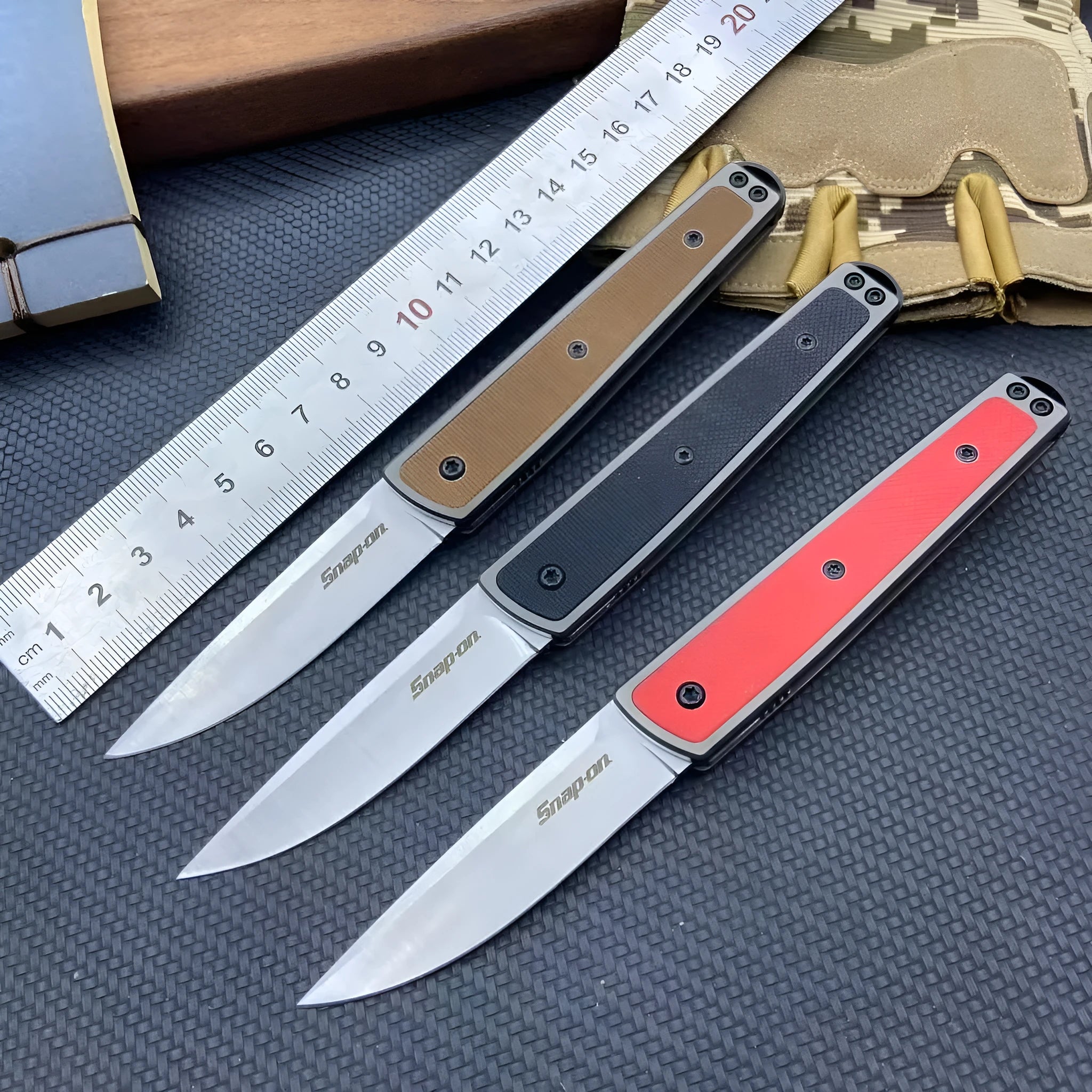 Folding fruit knife with stainless steel blade showing black, coffee colour, and red handle options