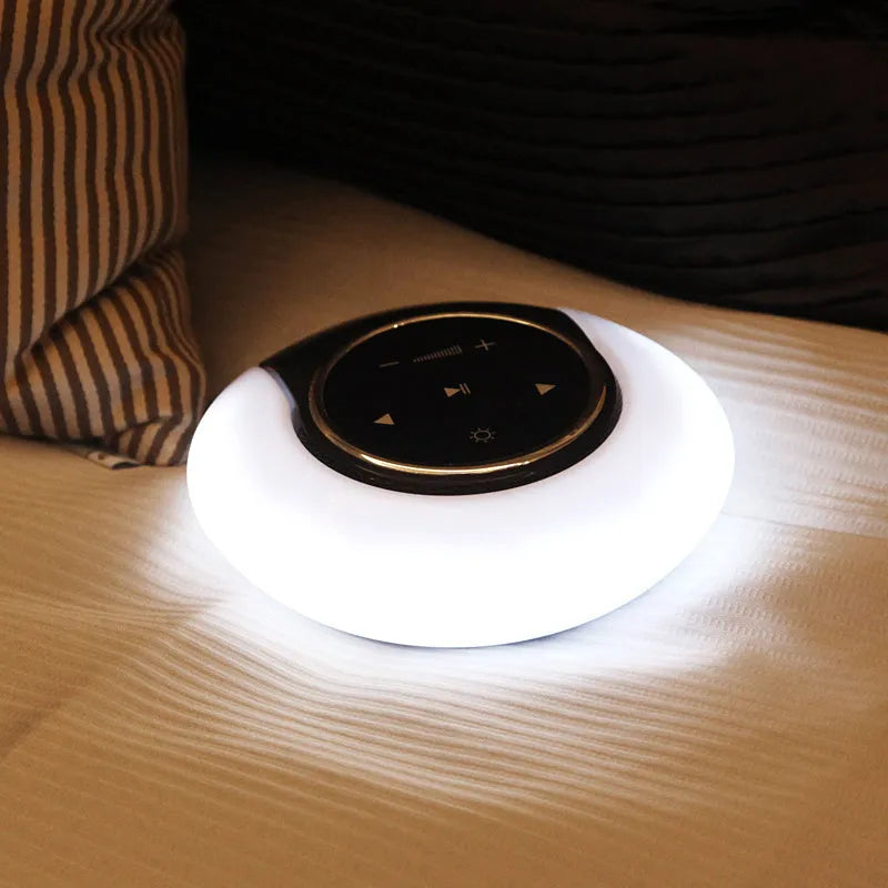 Blue and white Bluetooth speaker with integrated LED lamp showing touch controls and folding design