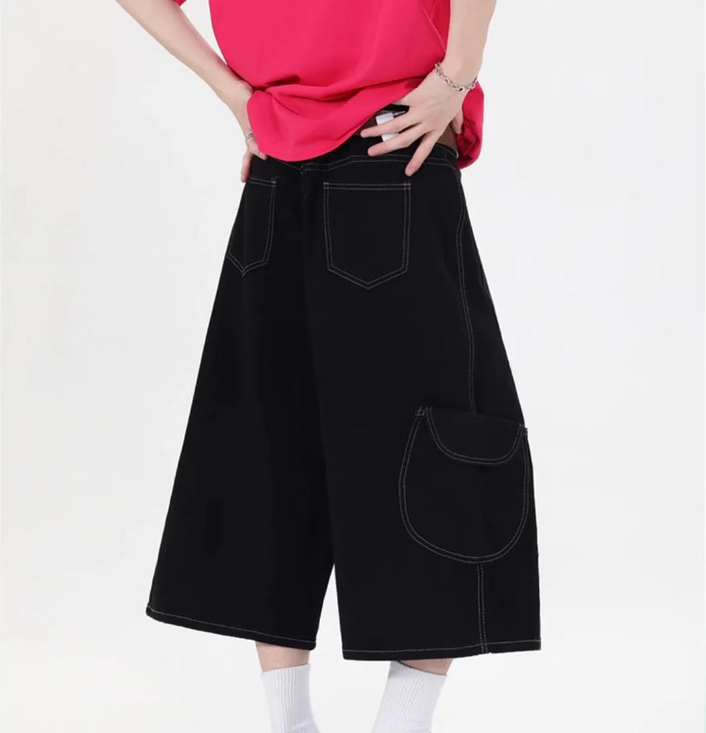 Black wide leg denim shorts with multiple pockets and cropped length on a mannequin