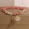 Women's strawberry quartz crystal bracelet with white agate beads and auspicious cloud charms