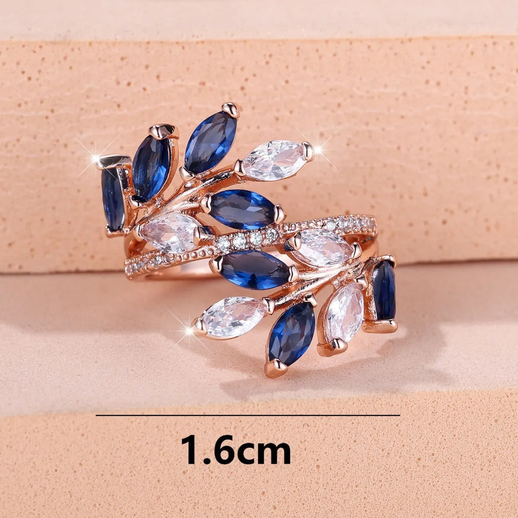 Copper leaf-shaped fashion ring with zircon details and an adjustable opening, shown in a rose gold finish.