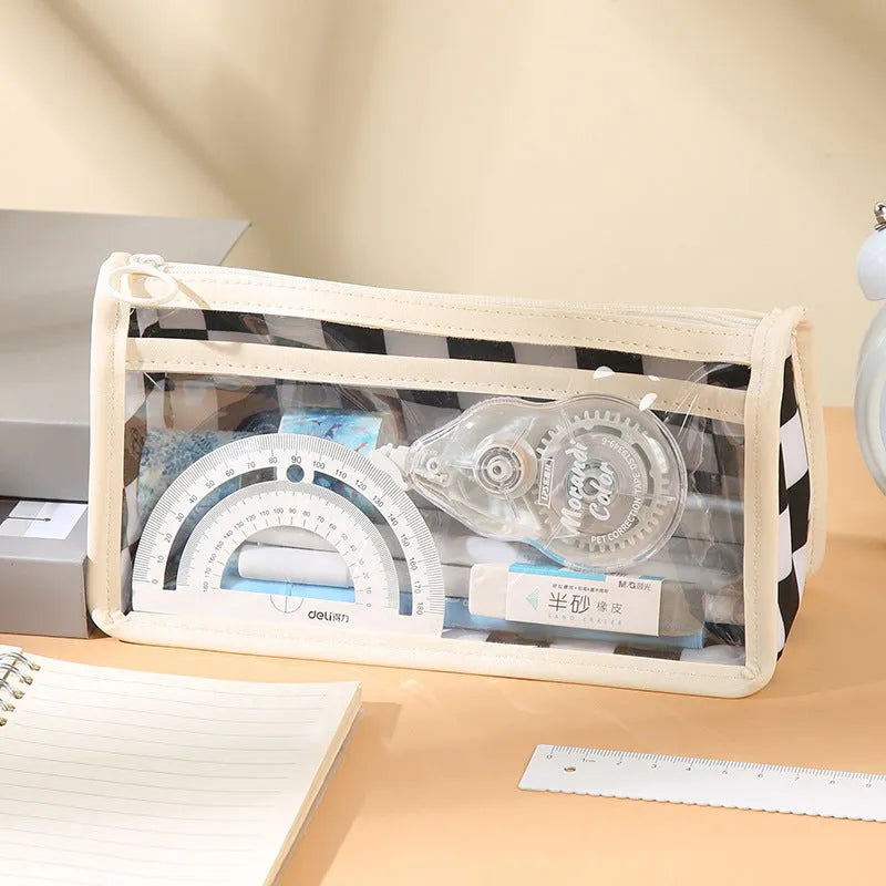 Transparent PVC pencil case with chessboard grid pattern showing pens inside, dimensions 21.5cm x 8cm x 11.5cm