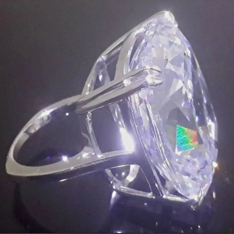 Women's white gold colour alloy ring with a simple inlaid square diamond on a geometric band.