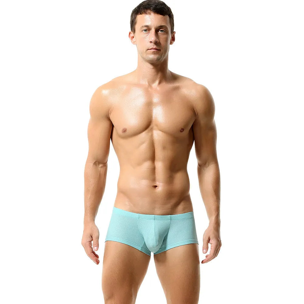 Solid colour men's nylon boxers with a mid-low waist, shown in orange, blue, green, and white.