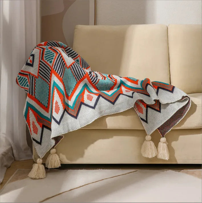 Bohemian-style acrylic sofa cover blanket with tassel trim in a geometric pattern colour option