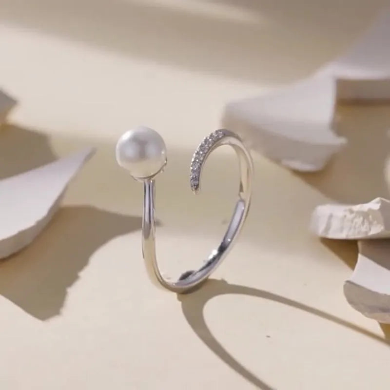 Sterling silver adjustable pearl ring with open loop design showing natural shell pearls on S925 silver band