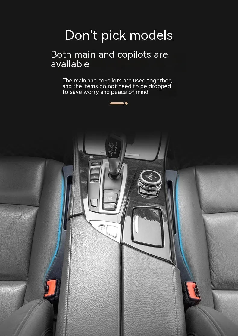 Black plastic car seat gap storage organiser box with a handle, shown inserted between vehicle seats.