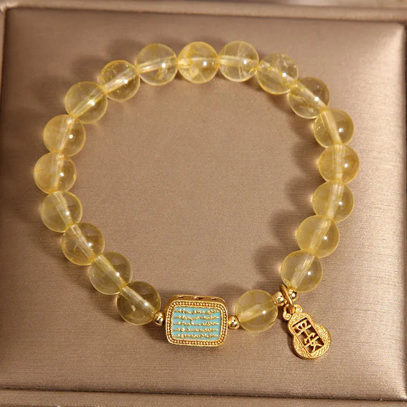 Women's yellow citrine crystal bracelet with rhinestone accents on wrist