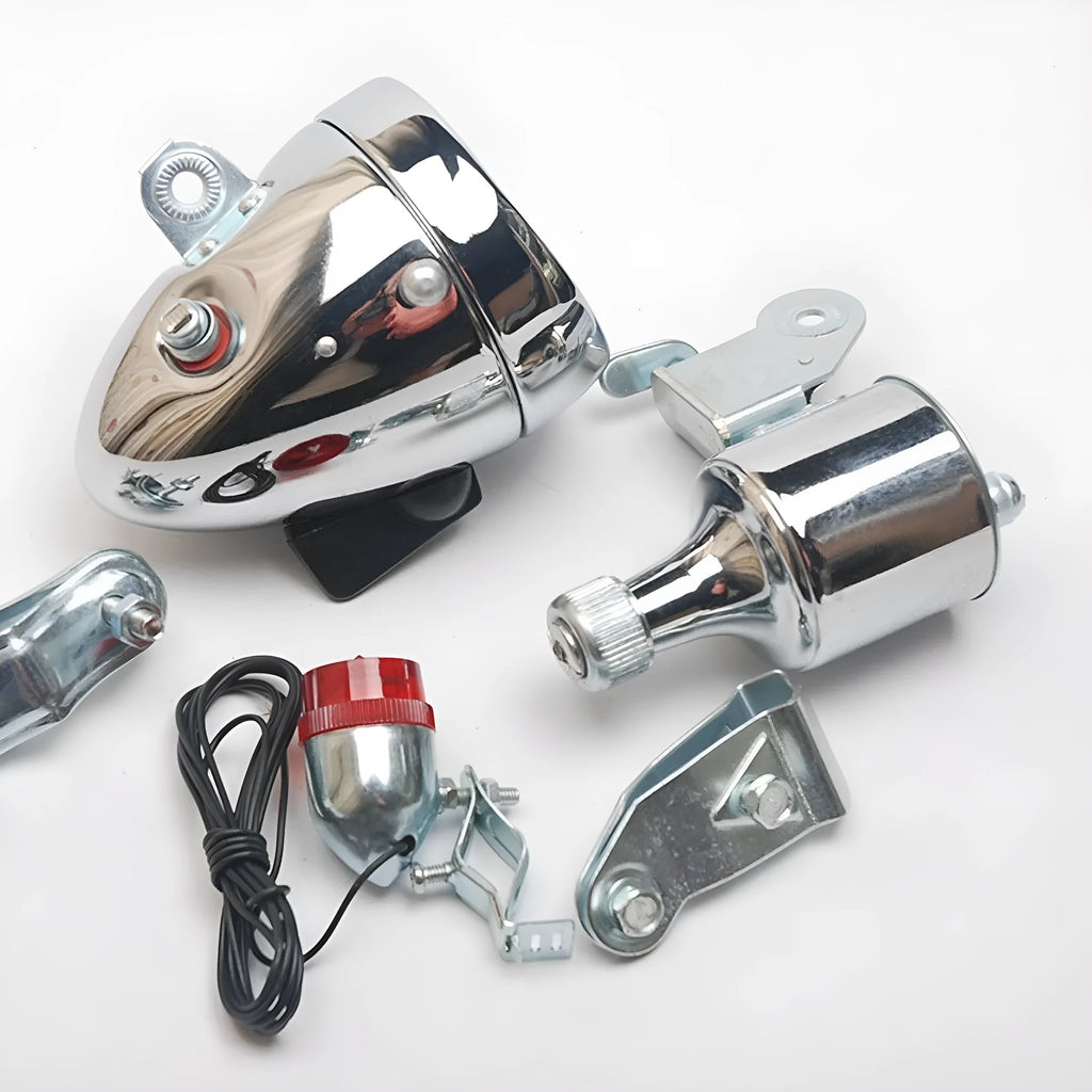 Silver bicycle dynamo generator light kit showing generator unit, wiring, and connectors for front or rear mounting.