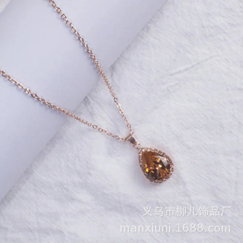 Drop-shaped pendant necklace with rhinestone and gemstone inlay in pink colour option