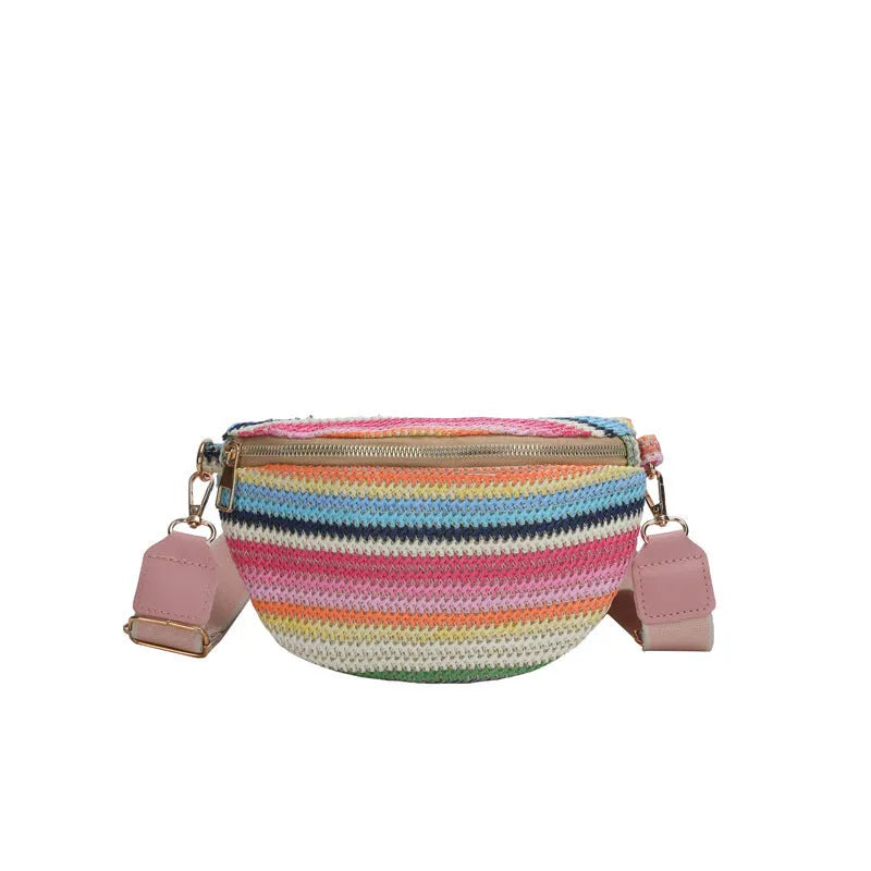 Women's blue bohemian straw beach bag with shell shape and single shoulder strap showing woven construction