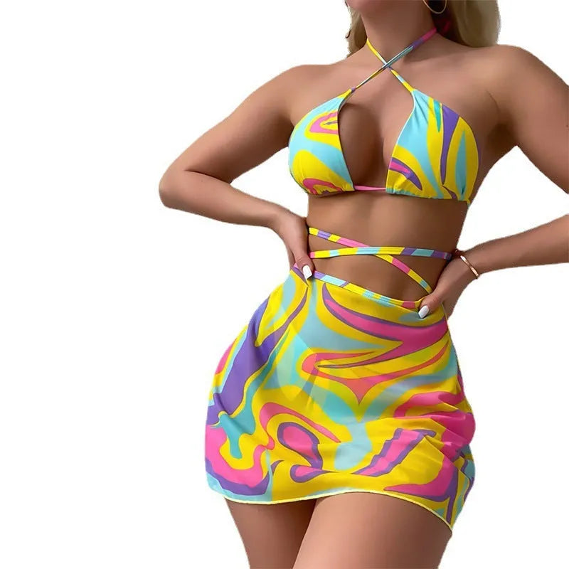 Yellow striped halter neck swimsuit with lace-up front, matching skirt, and shorts set for women.