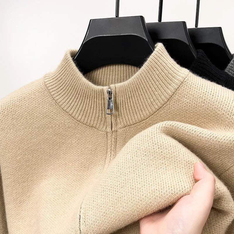 Man wearing a loose-fit, grey, stand collar knitted cardigan with a full-length front zipper.