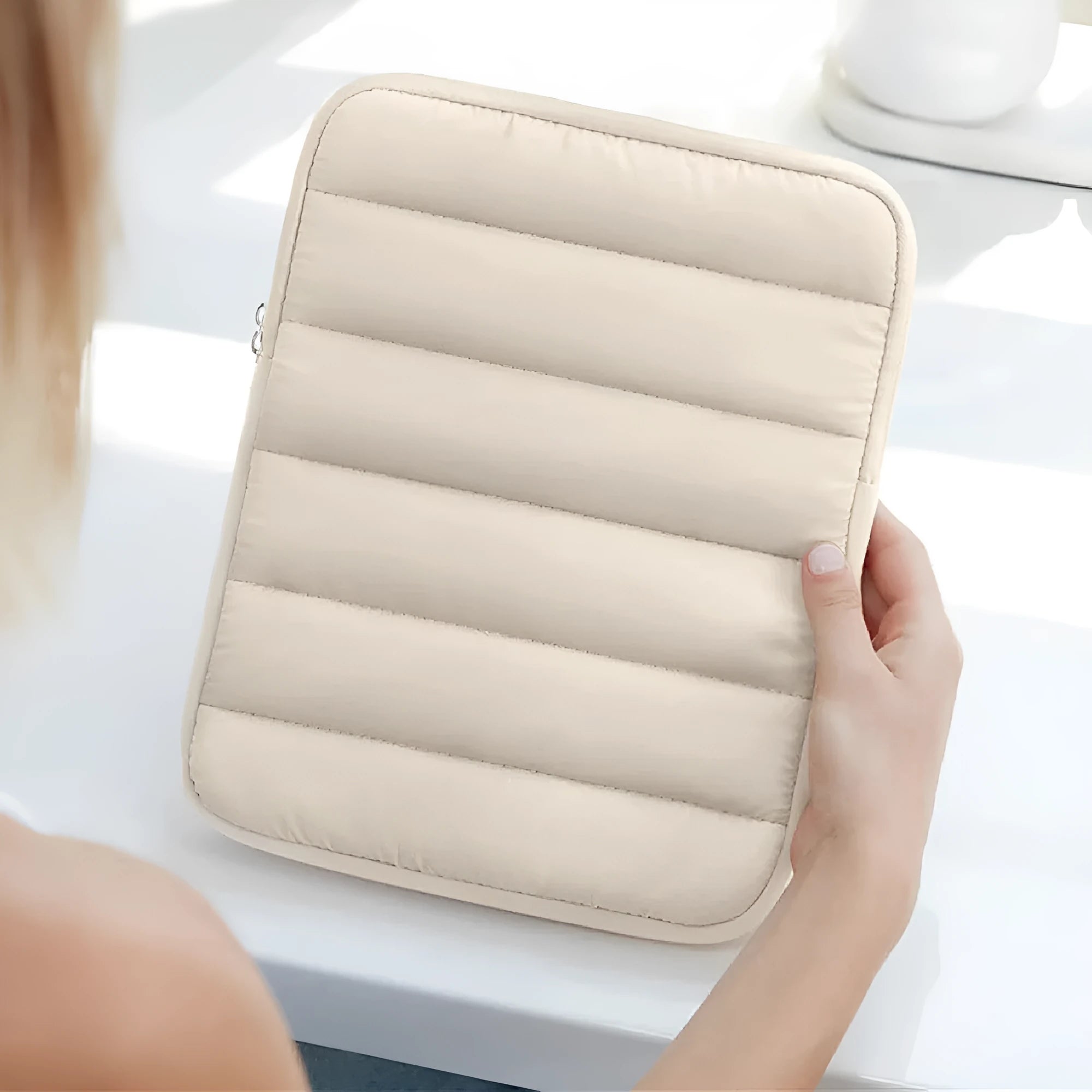 Puff bag laptop sleeve in black, khaki, or silver for 9.7 to 11 inch devices, showing fluffy padding and elastic sides.