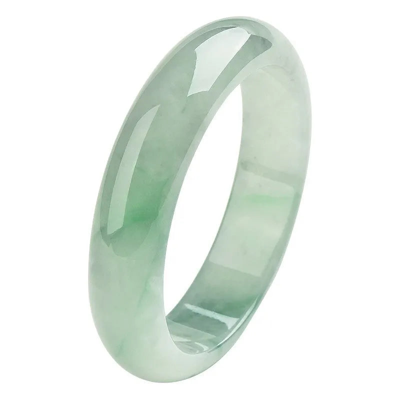 Light green jade bracelet showing natural stone colouration with size markings from 53 to 64