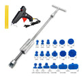 Automotive dent repair tool kit showing metal T-shaped hammer and blue adhesive pads for car body panel repair.
