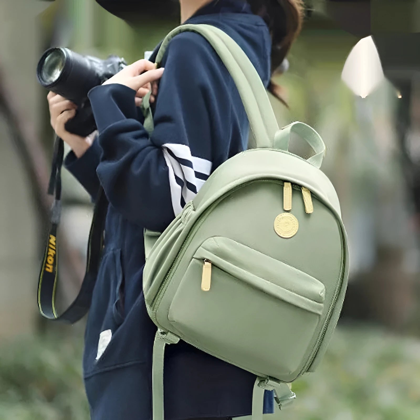 Green polyester shoulder camera bag for women with a detachable iPad compartment on a curve belt.