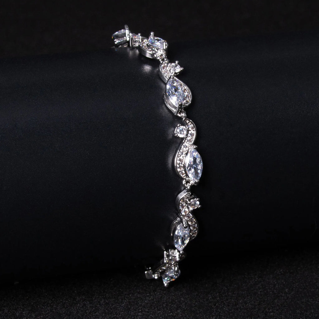 Women's copper geometric line bracelet with inlaid blue zircon stones on a white background