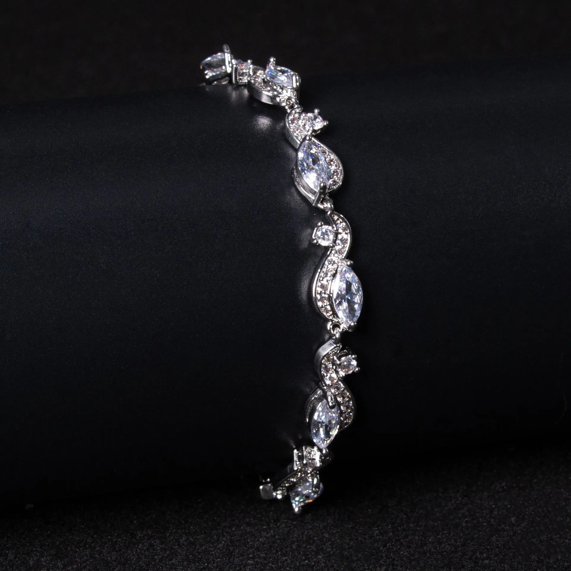 Women's copper geometric line bracelet with inlaid blue zircon stones on a white background
