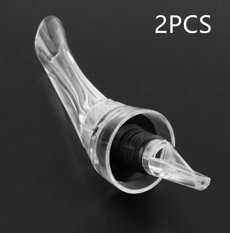 Clear acrylic wine aerator with stainless steel filter measuring 16x4.2cm pouring red wine into a glass