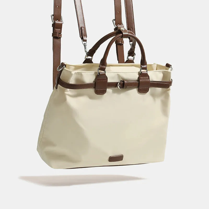 Women's nylon shoulder tote bag in a horizontal square shape showing internal organiser pockets.