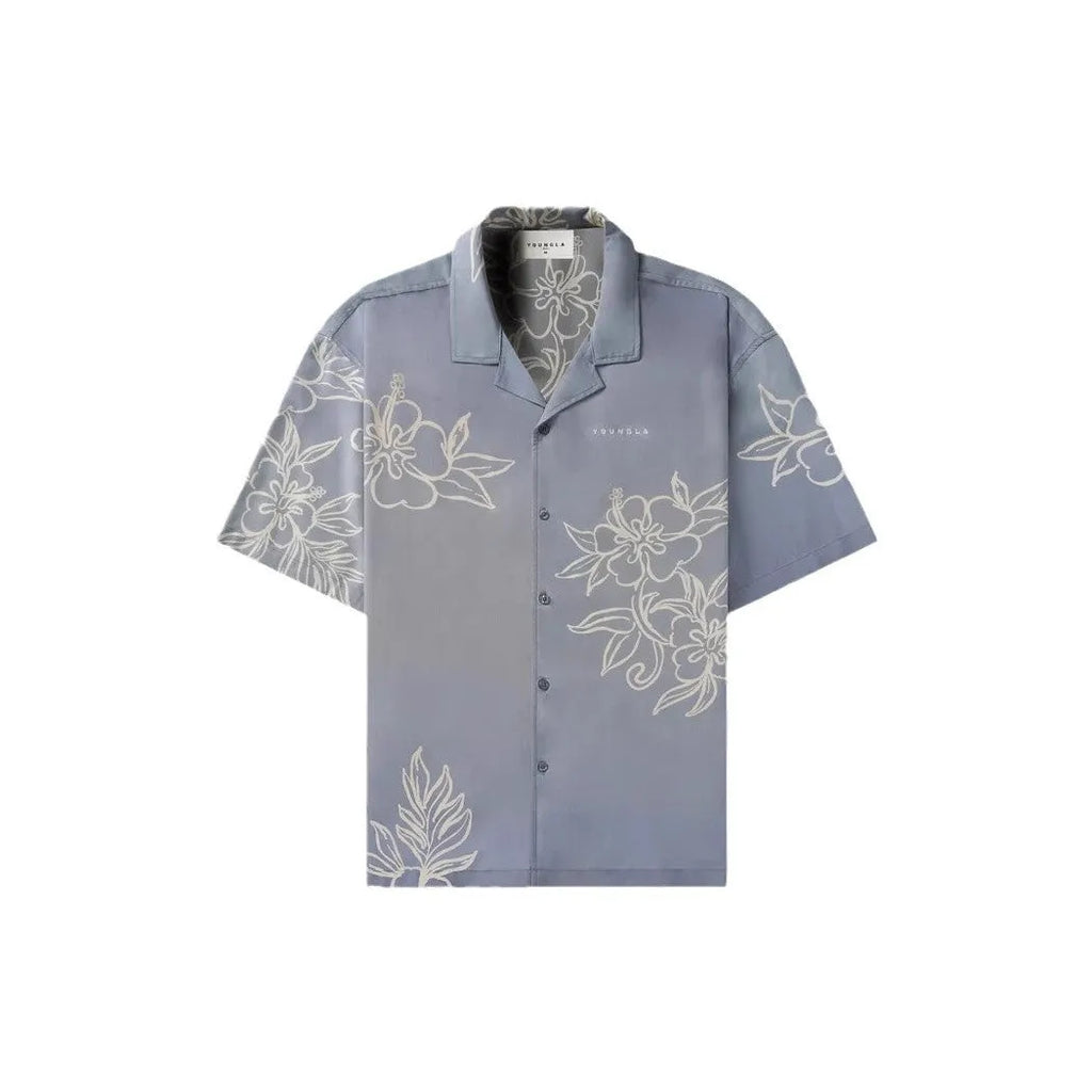 Man wearing a loose-fit, short-sleeve floral print cardigan in a light colour.