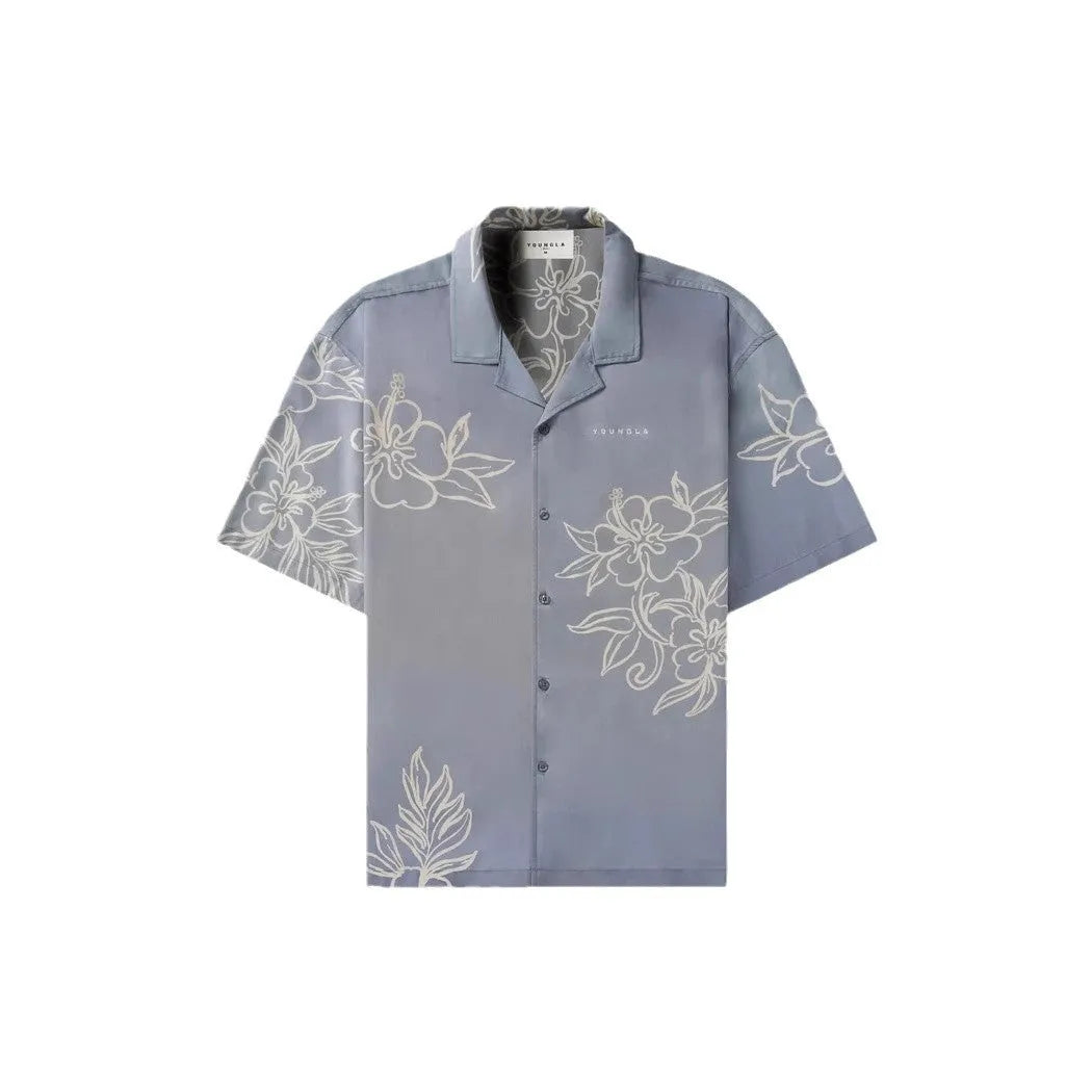 Man wearing a loose-fit, short-sleeve floral print cardigan in a light colour.