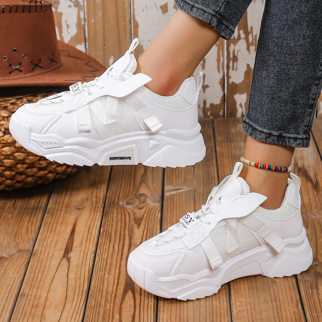 Women's purple platform sneakers with breathable mesh upper and white sole on a plain background.
