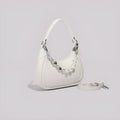 White PU crossbody shoulder bag with vertical square shape, three-dimensional outer pocket, and phone compartment.
