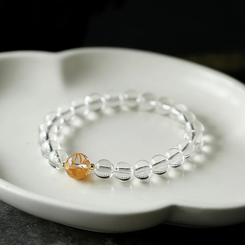 Geometric obsidian black agate and white crystal bracelet with golden dragon bead on adjustable cord.