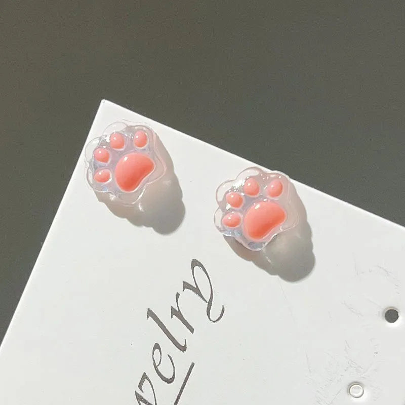 Cat paw magnetic ear clips in transparent pink, black, and white, plastic resin, 1 pair for female students