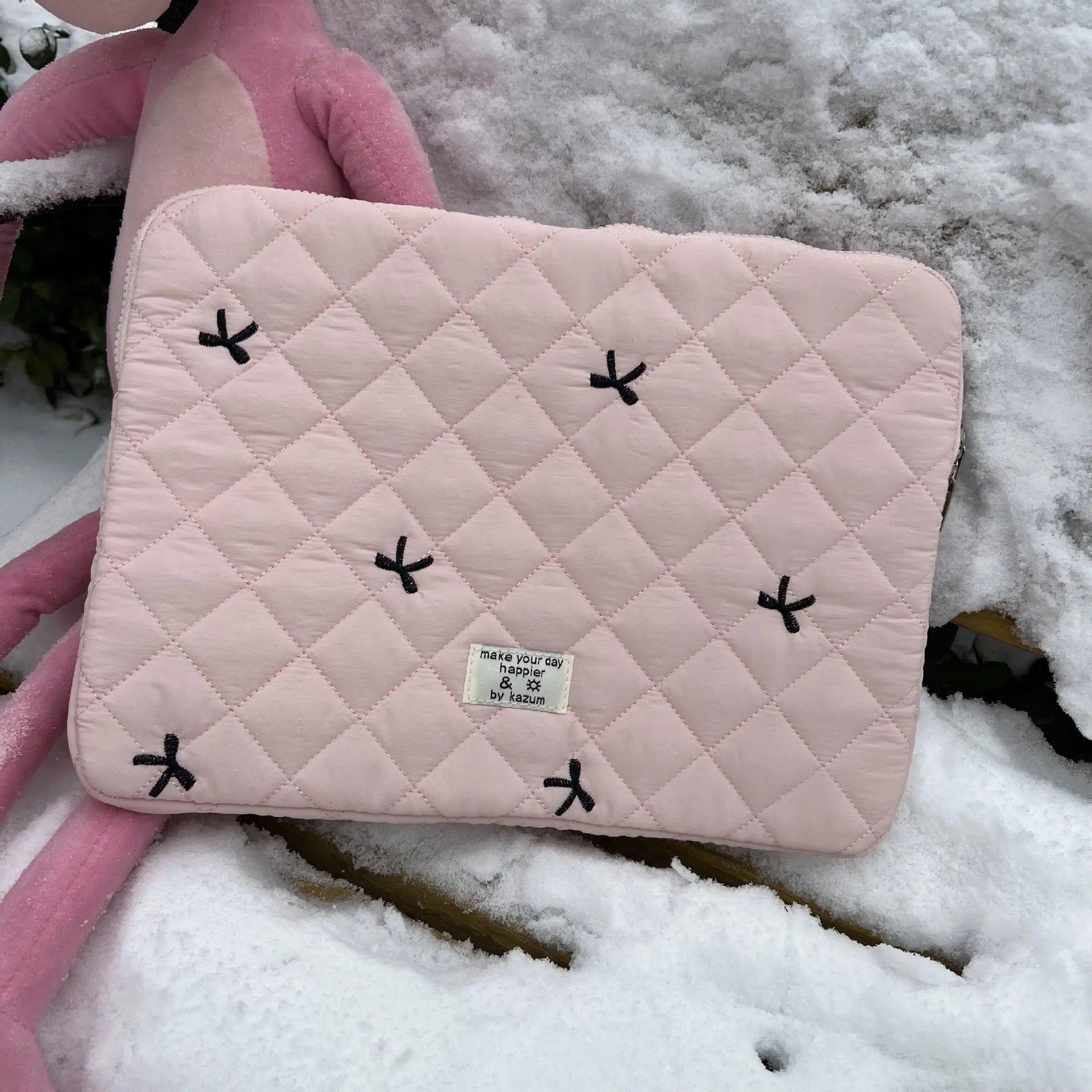 Cute rhombus embroidered bow laptop storage bag in nylon, shown in light pink colour.