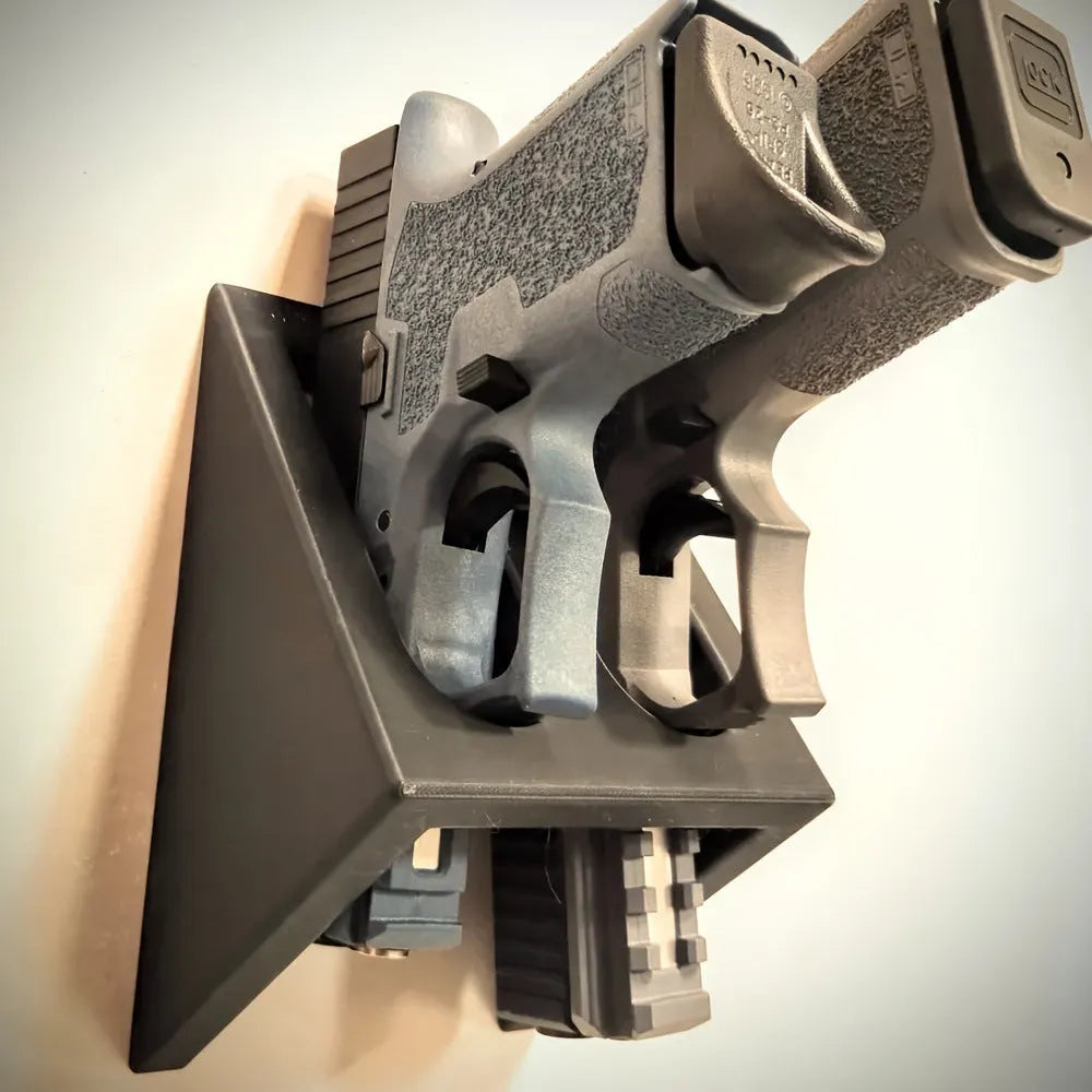 Black plastic punk-style pistol display stand for collectible models.