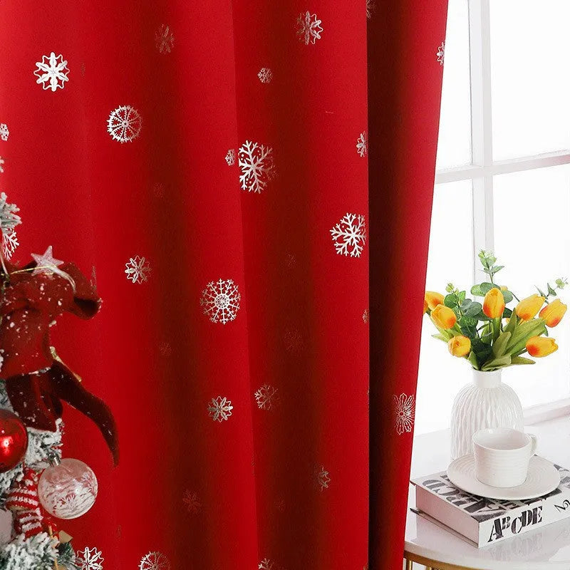 Red snowflake pattern shade cloth curtain with lace loops hanging against window