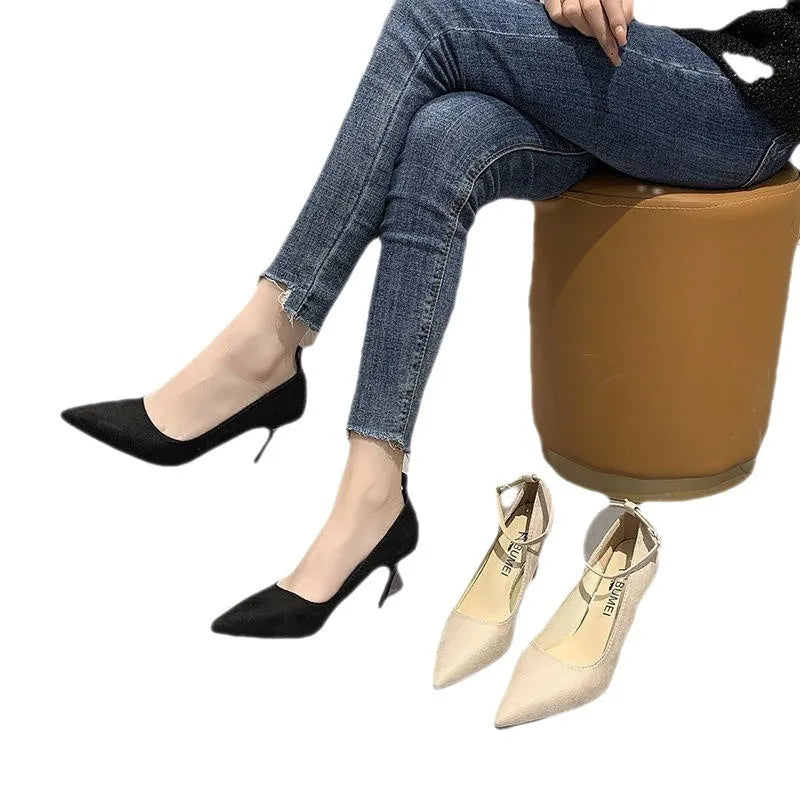 Women's black stiletto heel pump shoe with a silver buckle detail on the side.