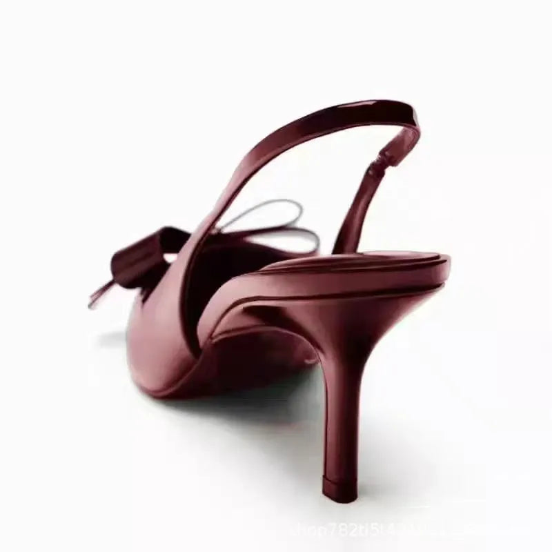 Wine red patent leather open-back high heels with bow detail and rear lacing