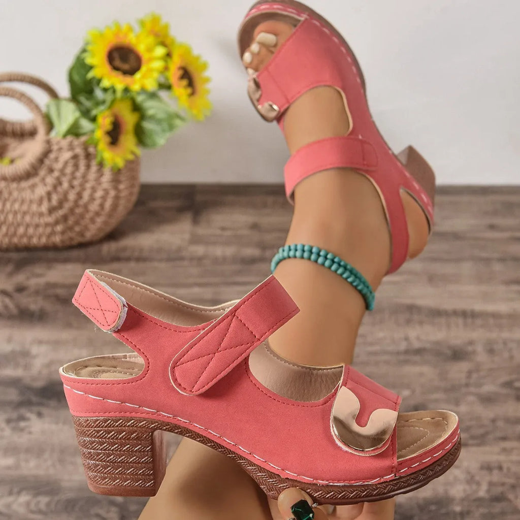 Light brown Roman-style sandals with a Velcro strap fastener, round toe, and rubber sole.
