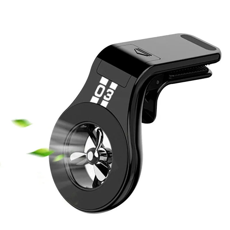 Black magnetic car phone holder clipped to car air vent with smartphone attached and fragrance pads
