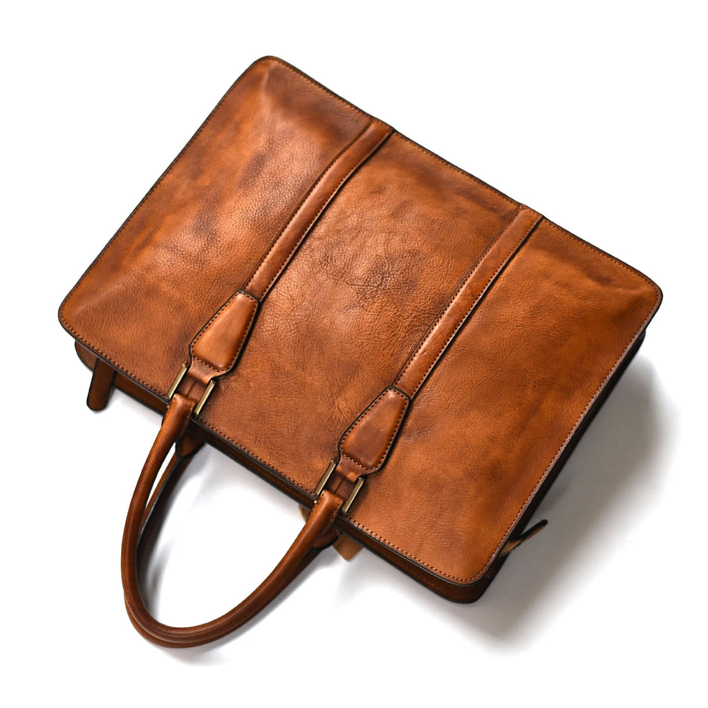 Men's brown leather horizontal business handbag with zipper closure shown from the front.